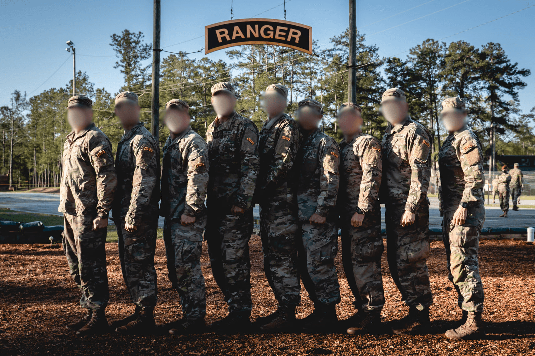 Military squad standing under ranger gate in formation